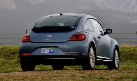 Blue Volkswagen Beetle viewed from the rear and side